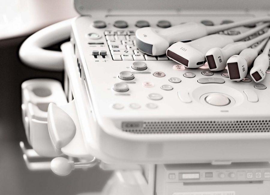 Various ultrasound sensors lie on the keyboard of the ultrasound machine